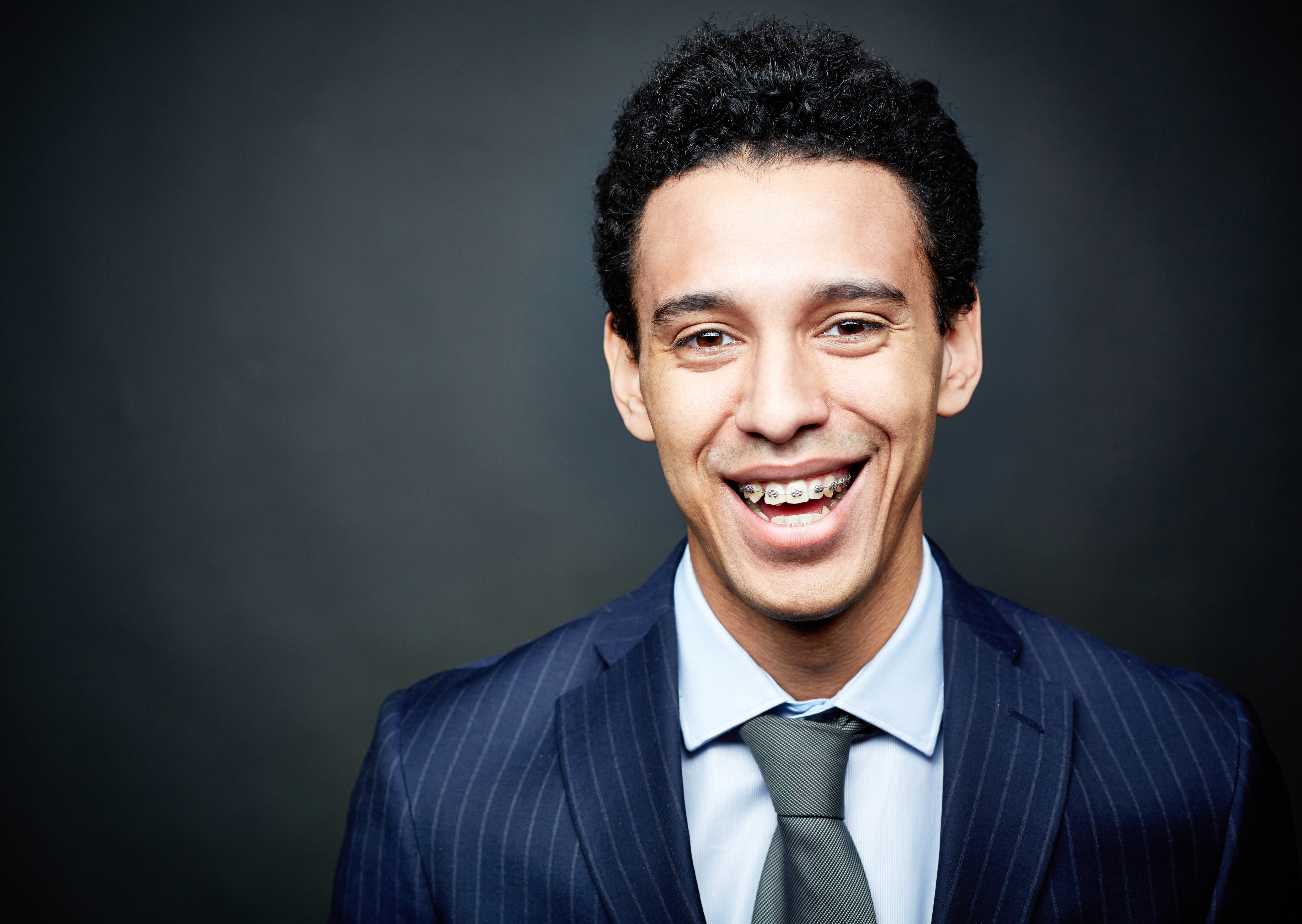 man smiling with braces